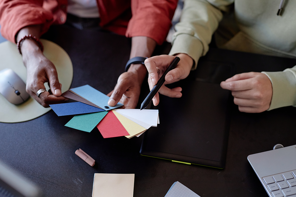 Team reviewing color swatches and design options together, representing collaborative branding and custom product design.